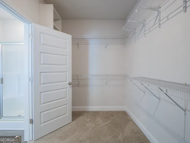 a white toilet sitting next to a white wall