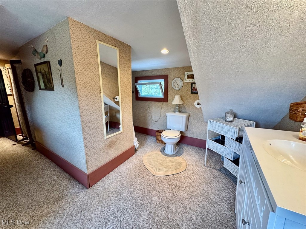 1188 Frys Valley Road Southwest New Philadelphia, OH 44663 - Photo 41 of 50 Bathroom with vanity, wallpapered walls, and a textured ceiling