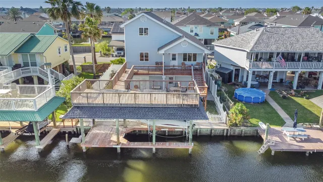 an aerial view of a house with swimming pool and porch