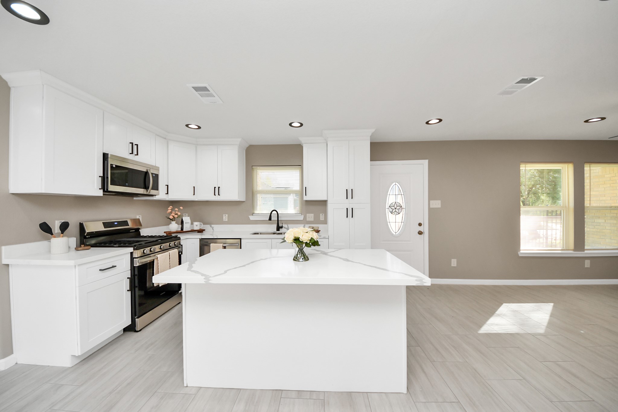8918 Vinearbor Street Houston, TX 77033 - Photo 13 of 35 a kitchen with stainless steel appliances granite countertop a sink a stove top oven a counter space and cabinets