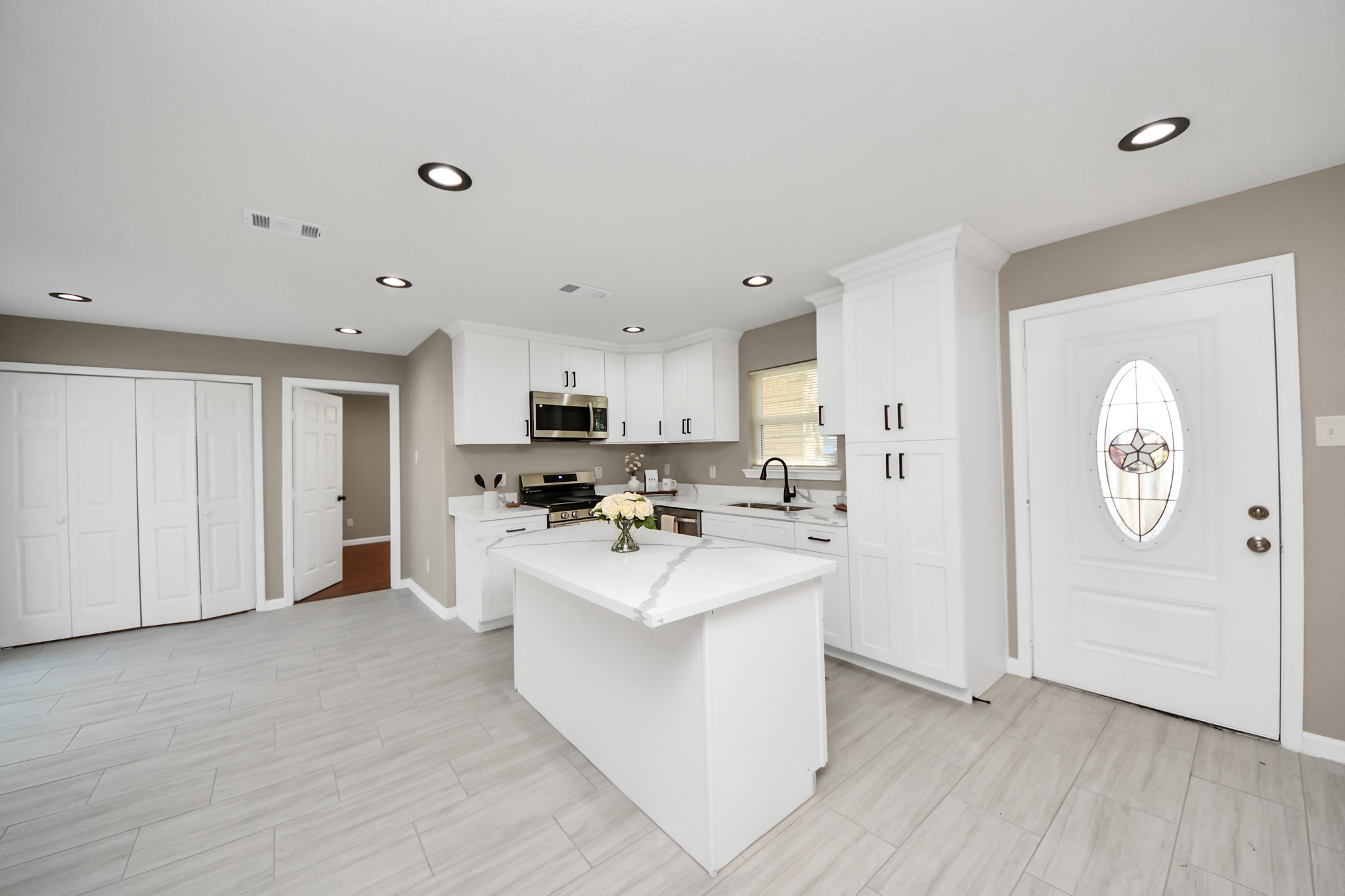 8918 Vinearbor Street Houston, TX 77033 - Photo 15 of 35 a kitchen with stainless steel appliances a white stove top oven cabinets and a refrigerator