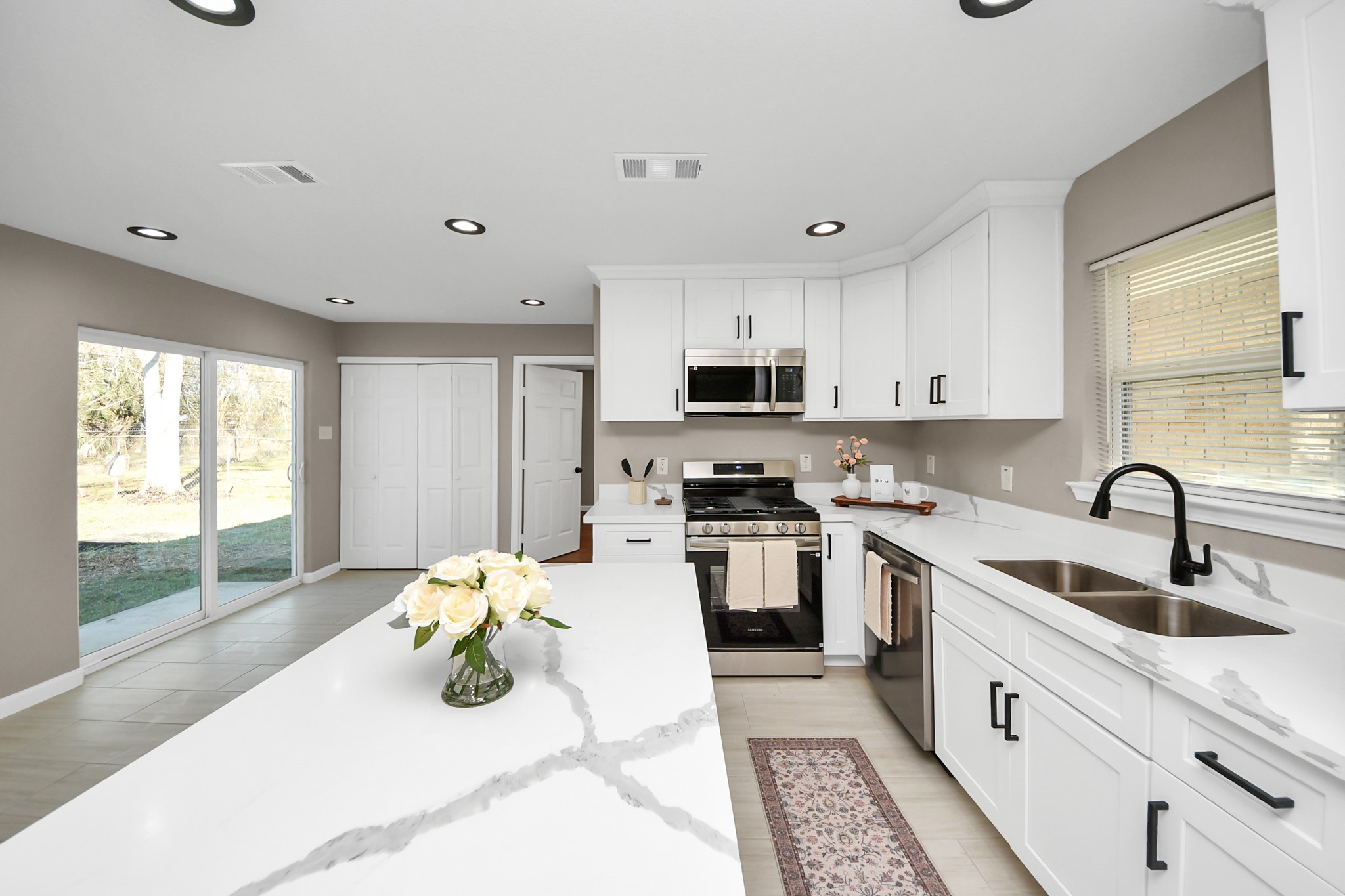 8918 Vinearbor Street Houston, TX 77033 - Photo 16 of 35 a kitchen with a sink a counter top space stainless steel appliances and cabinets