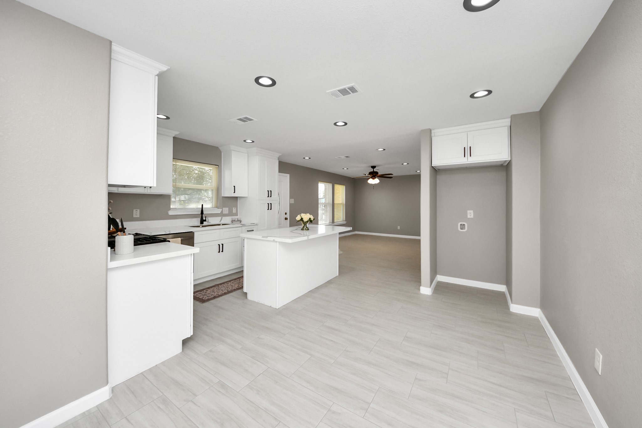 8918 Vinearbor Street Houston, TX 77033 - Photo 21 of 35 a large kitchen with a lot of white cabinets and stainless steel appliances