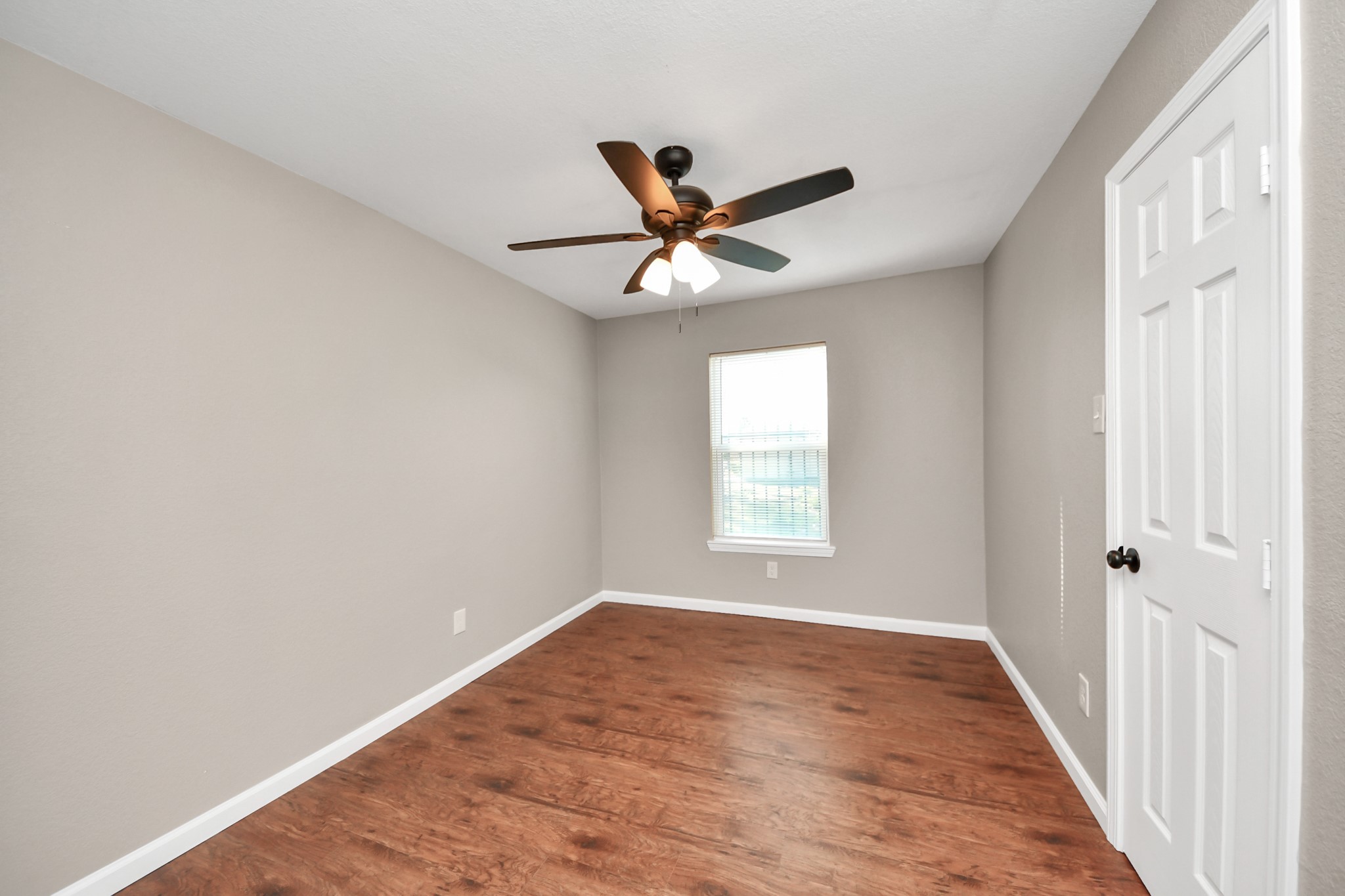 8918 Vinearbor Street Houston, TX 77033 - Photo 24 of 35 wooden floor in an empty room with a window