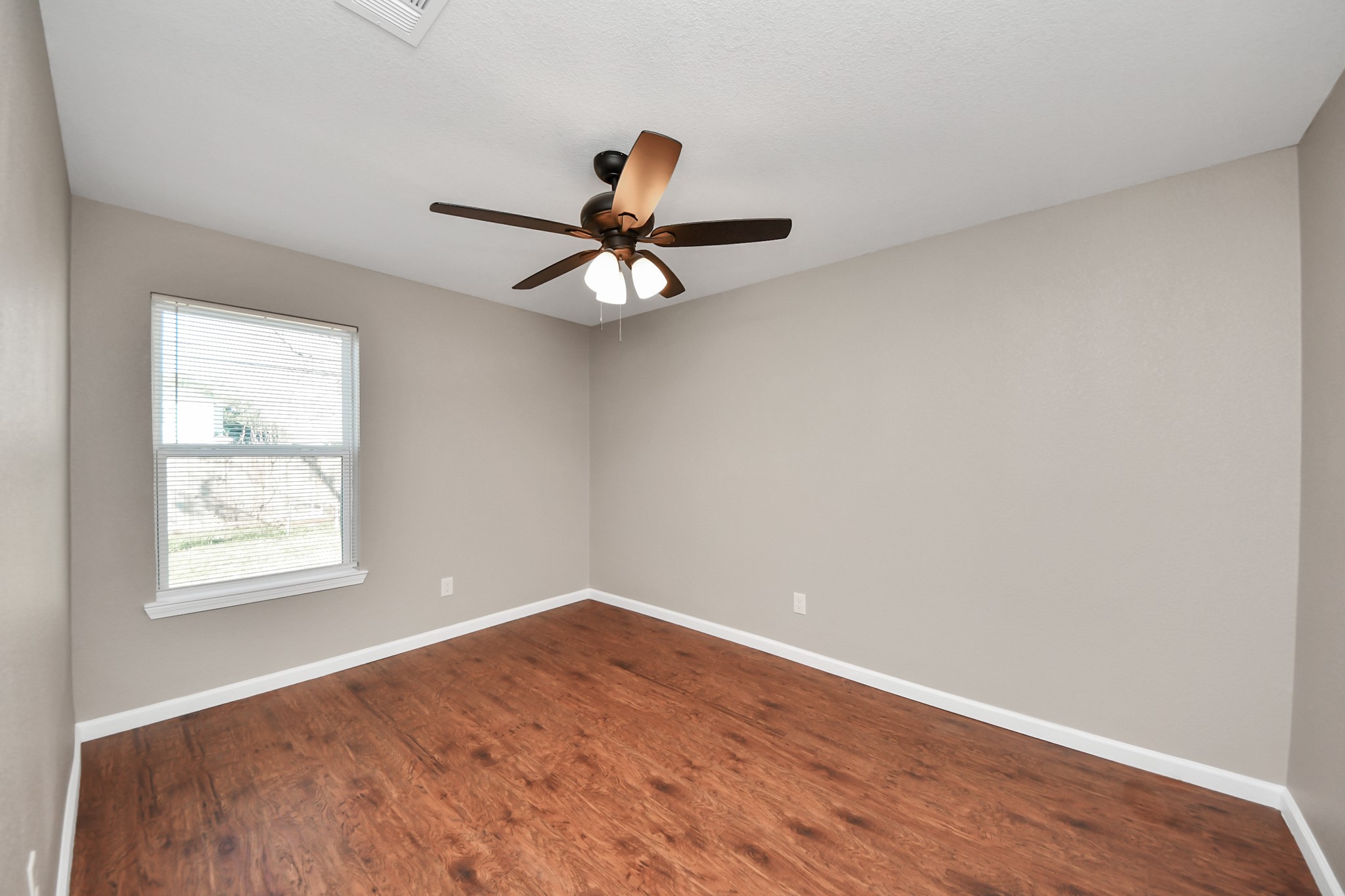 8918 Vinearbor Street Houston, TX 77033 - Photo 26 of 35 an empty room with a window and a fan