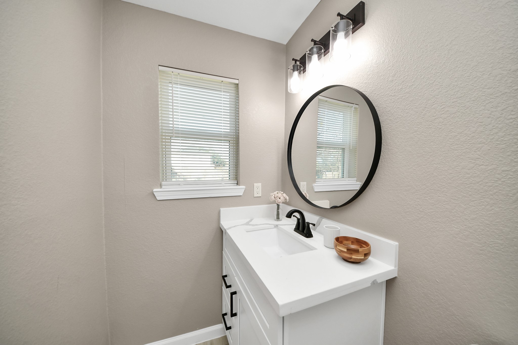 8918 Vinearbor Street Houston, TX 77033 - Photo 29 of 35 a bathroom with a sink and a mirror