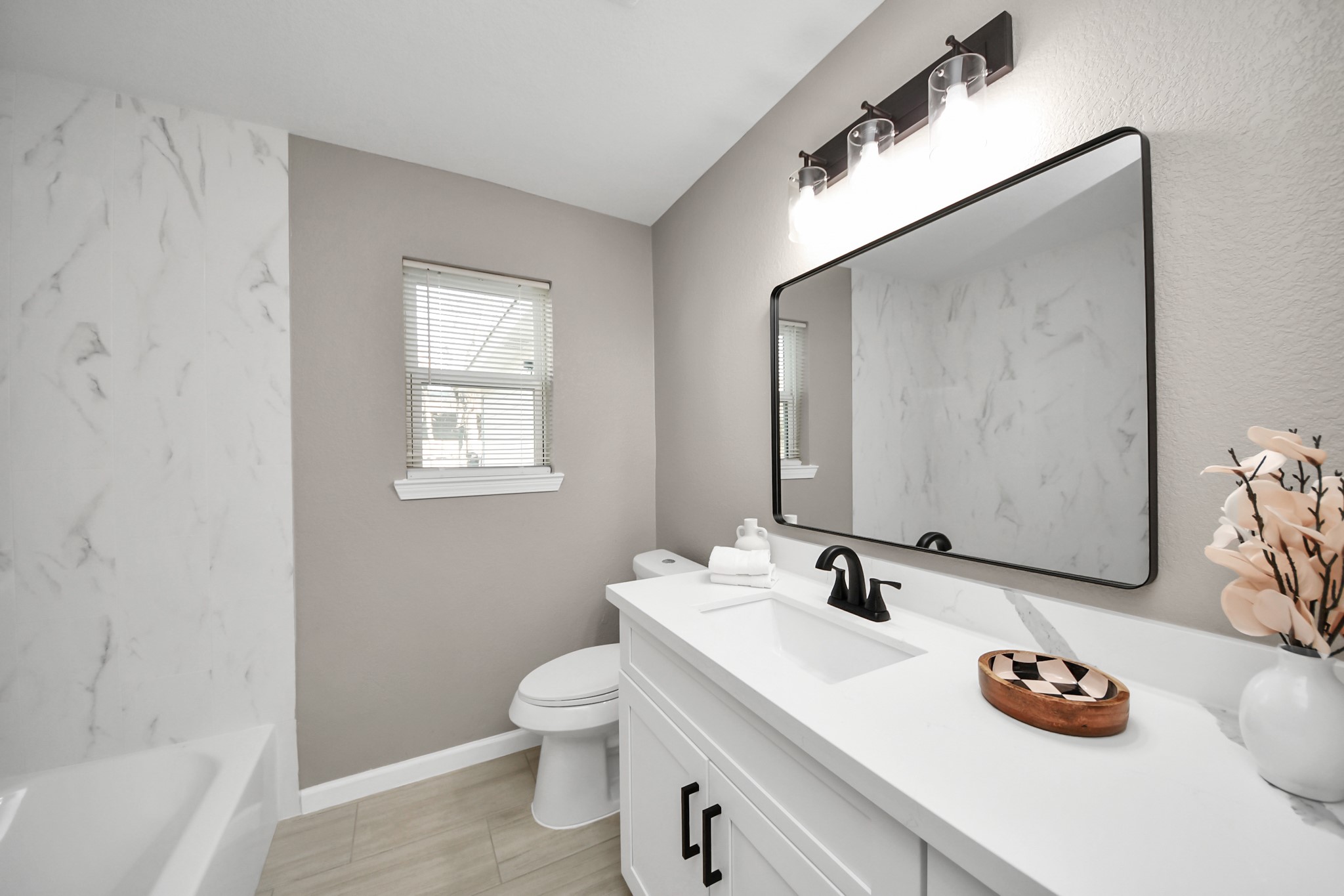 8918 Vinearbor Street Houston, TX 77033 - Photo 30 of 35 a bathroom with a sink a toilet and a mirror
