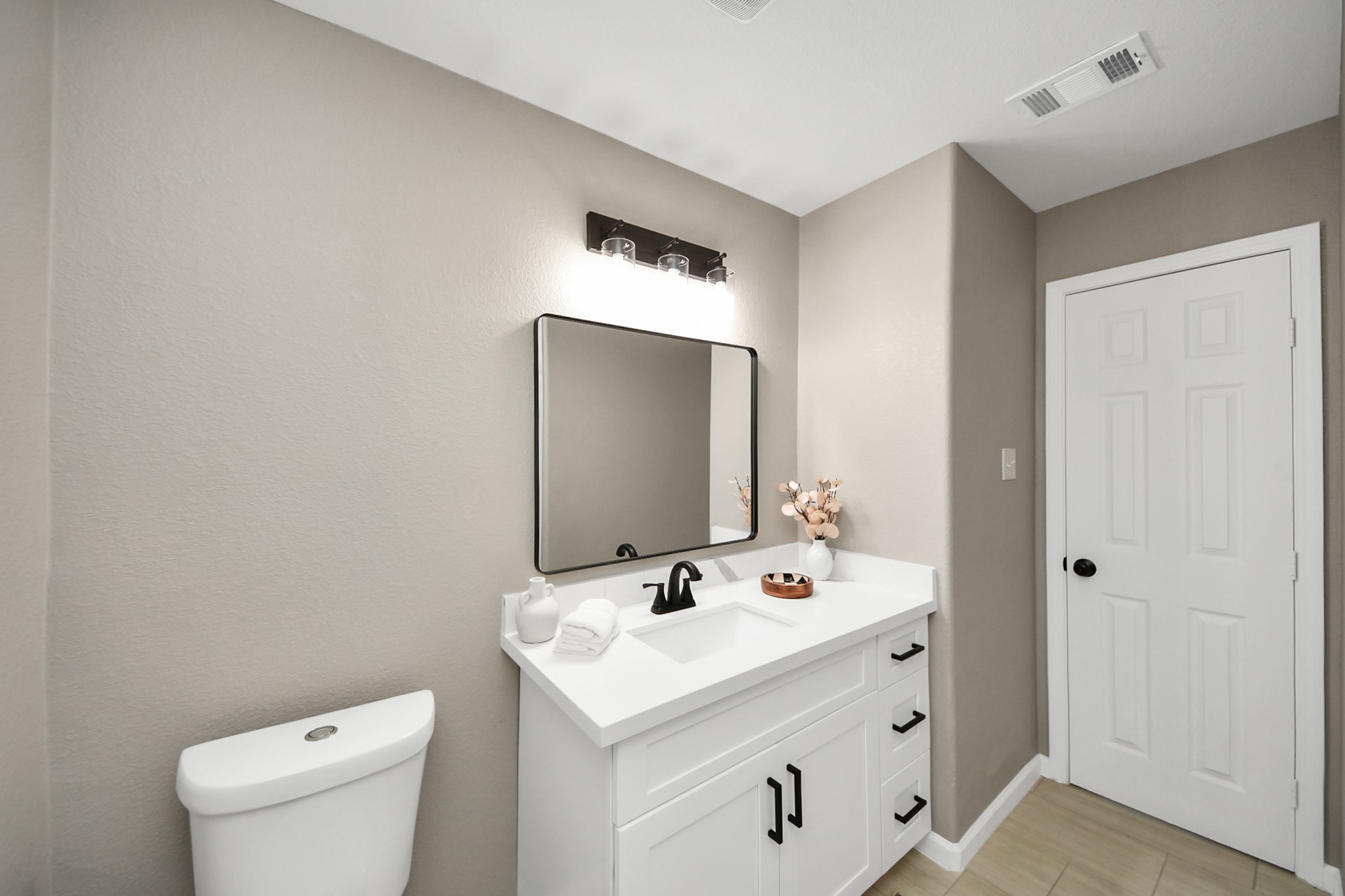 8918 Vinearbor Street Houston, TX 77033 - Photo 31 of 35 a bathroom with a sink a toilet and a mirror