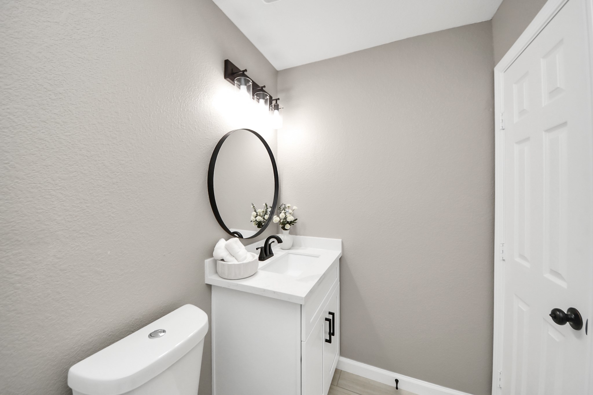 8918 Vinearbor Street Houston, TX 77033 - Photo 34 of 35 a bathroom with a toilet sink and mirror