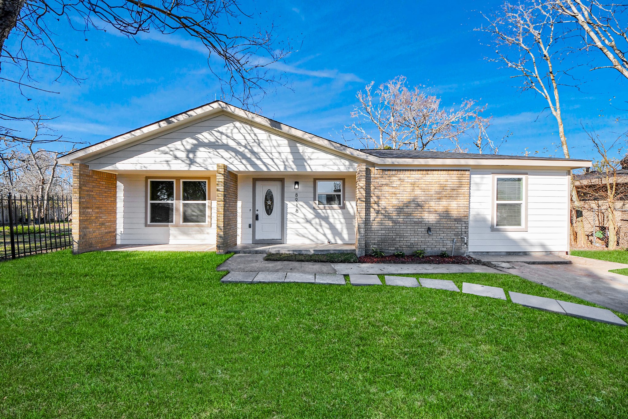 8918 Vinearbor Street Houston, TX 77033 - Photo 8 of 35 a front view of a house with a yard and garage