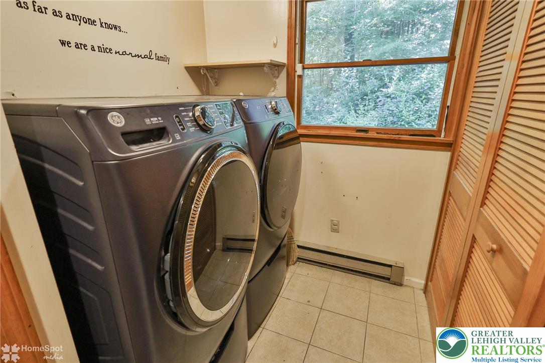 60 Sassafras Road Lehighton, PA 18235 - Photo 34 of 36 A well-appointed utility room features convenient laundry appliances and tiled flooring for easy maintenance.