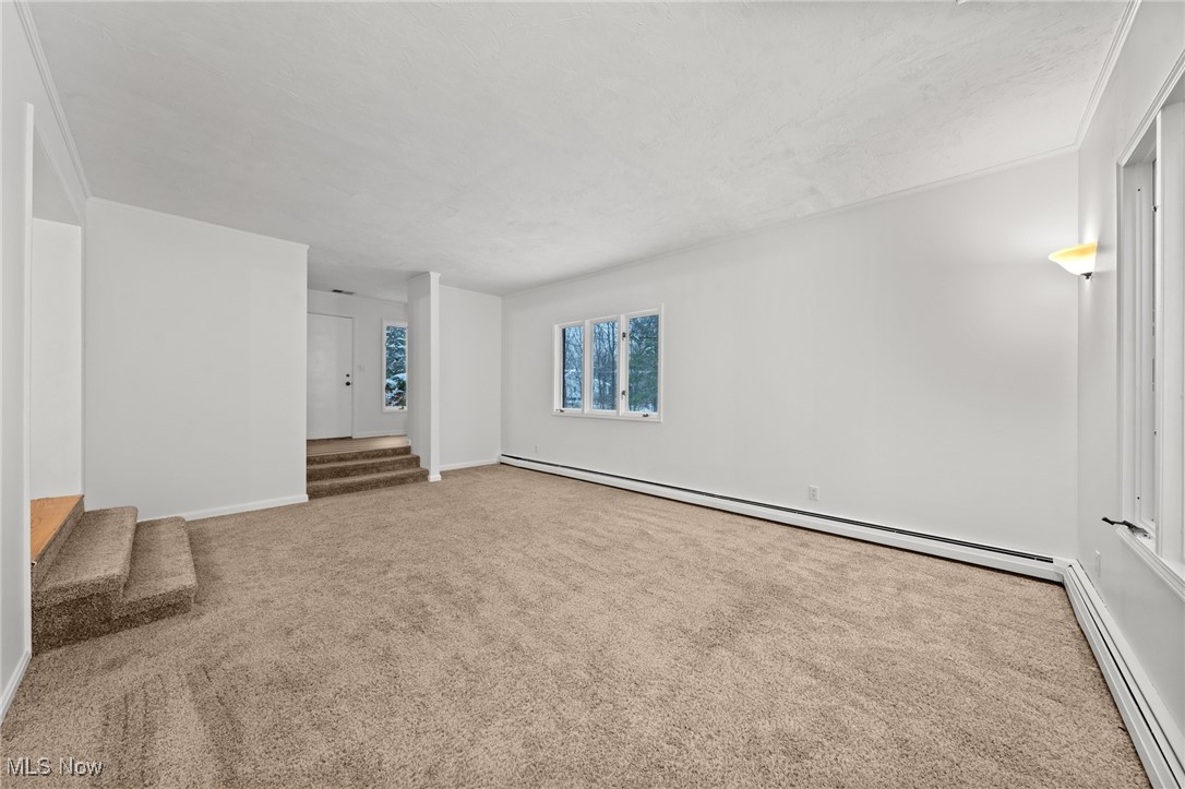 9513 Booth Road Willoughby, OH 44094 - Photo 7 of 45 Carpeted spare room featuring a baseboard heating unit
