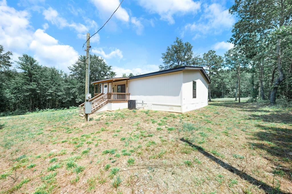 211 3900th Road Gilmer, TX 75644 - Photo 26 of 30 a house with trees in the background