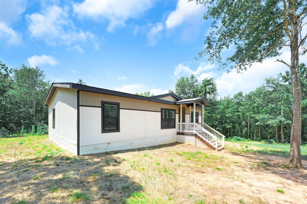 211 3900th Road Gilmer, TX 75644 - Photo 28 of 30 a view of a house with a yard