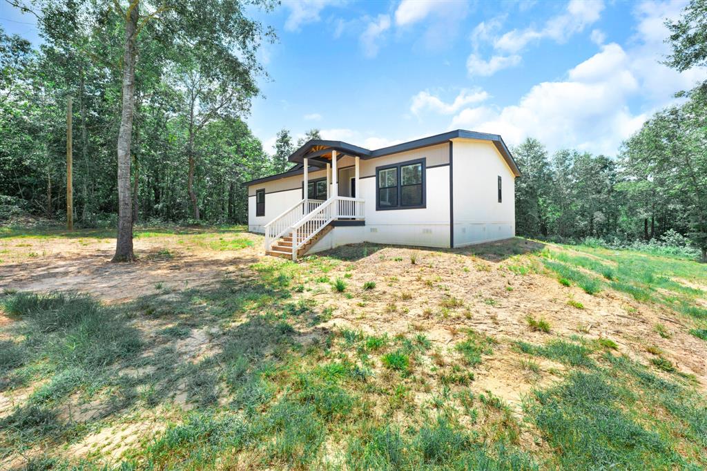 211 3900th Road Gilmer, TX 75644 - Photo 29 of 30 a house that has a tree in front of it