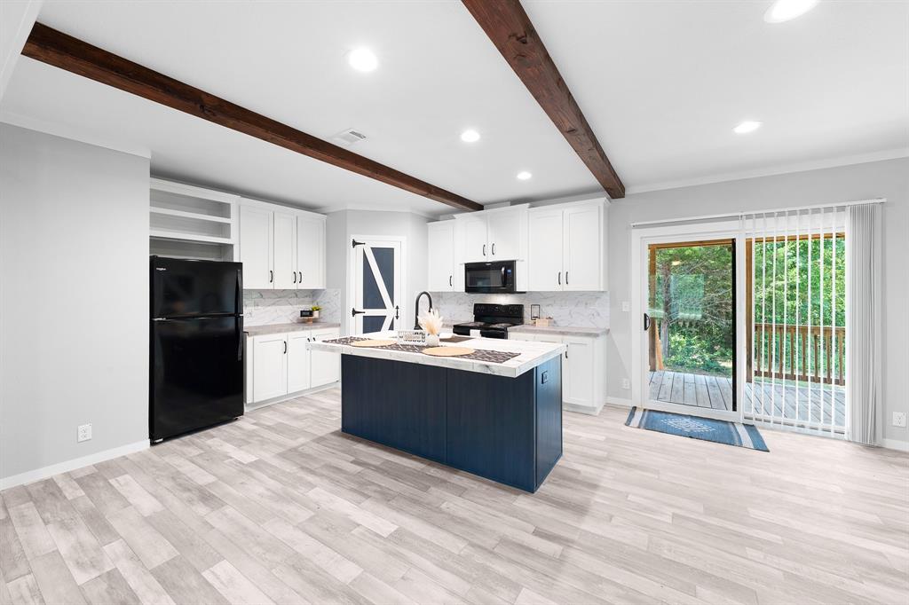 211 3900th Road Gilmer, TX 75644 - Photo 3 of 30 a large kitchen with kitchen island a sink stainless steel appliances and cabinets
