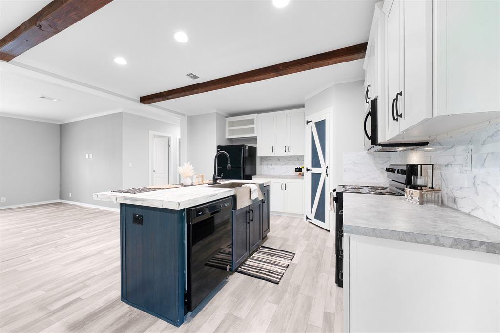 211 3900th Road Gilmer, TX 75644 - Photo 7 of 30 a kitchen with stainless steel appliances granite countertop a sink stove and refrigerator