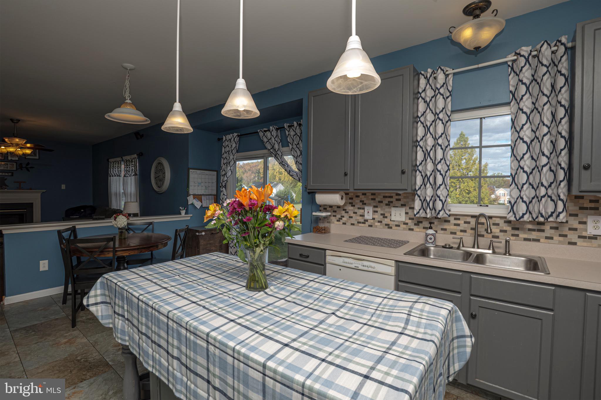 27 Basalt Street Townsend, DE 19734 - Photo 13 of 45 a dining room with wooden floor a chandelier a wooden table and chairs