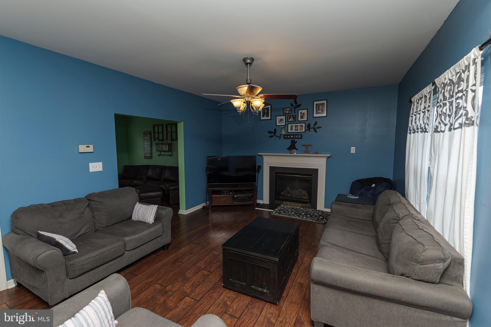 27 Basalt Street Townsend, DE 19734 - Photo 18 of 45 a living room with furniture a fireplace and a chandelier