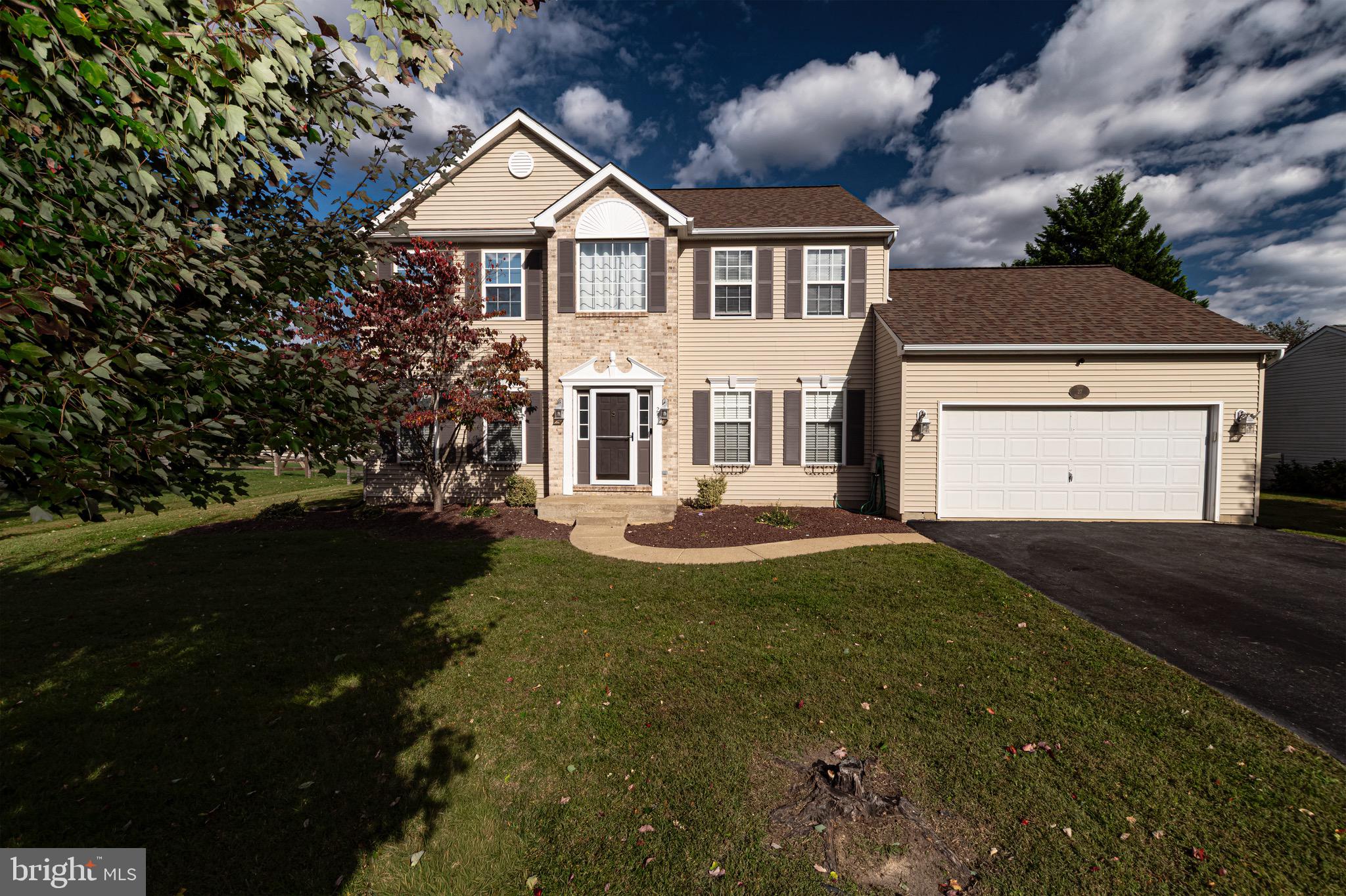 27 Basalt Street Townsend, DE 19734 - Photo 2 of 45 a front view of a house with a yard and garage