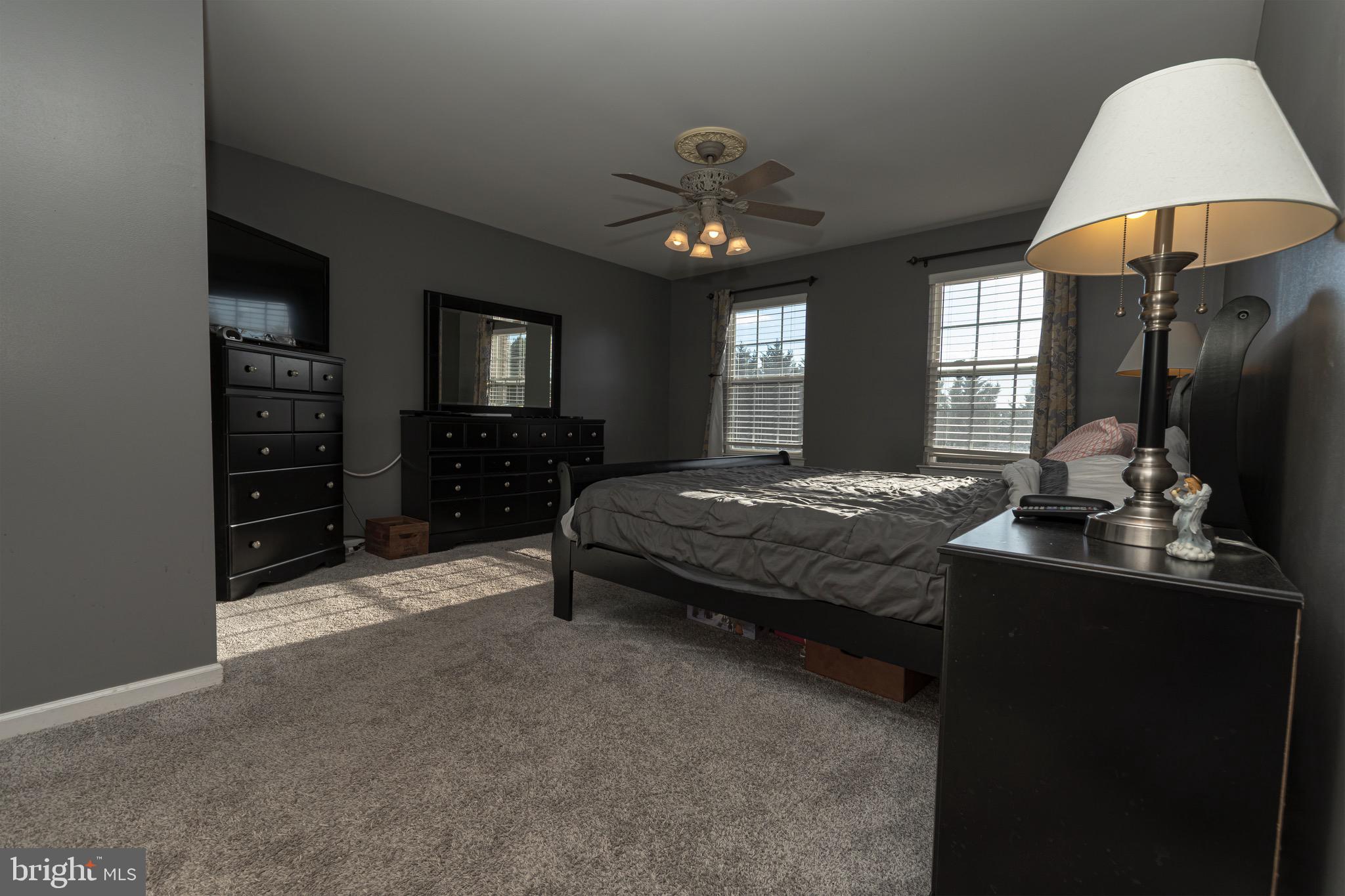 27 Basalt Street Townsend, DE 19734 - Photo 23 of 45 a bedroom with a bed and a lamp on dresser