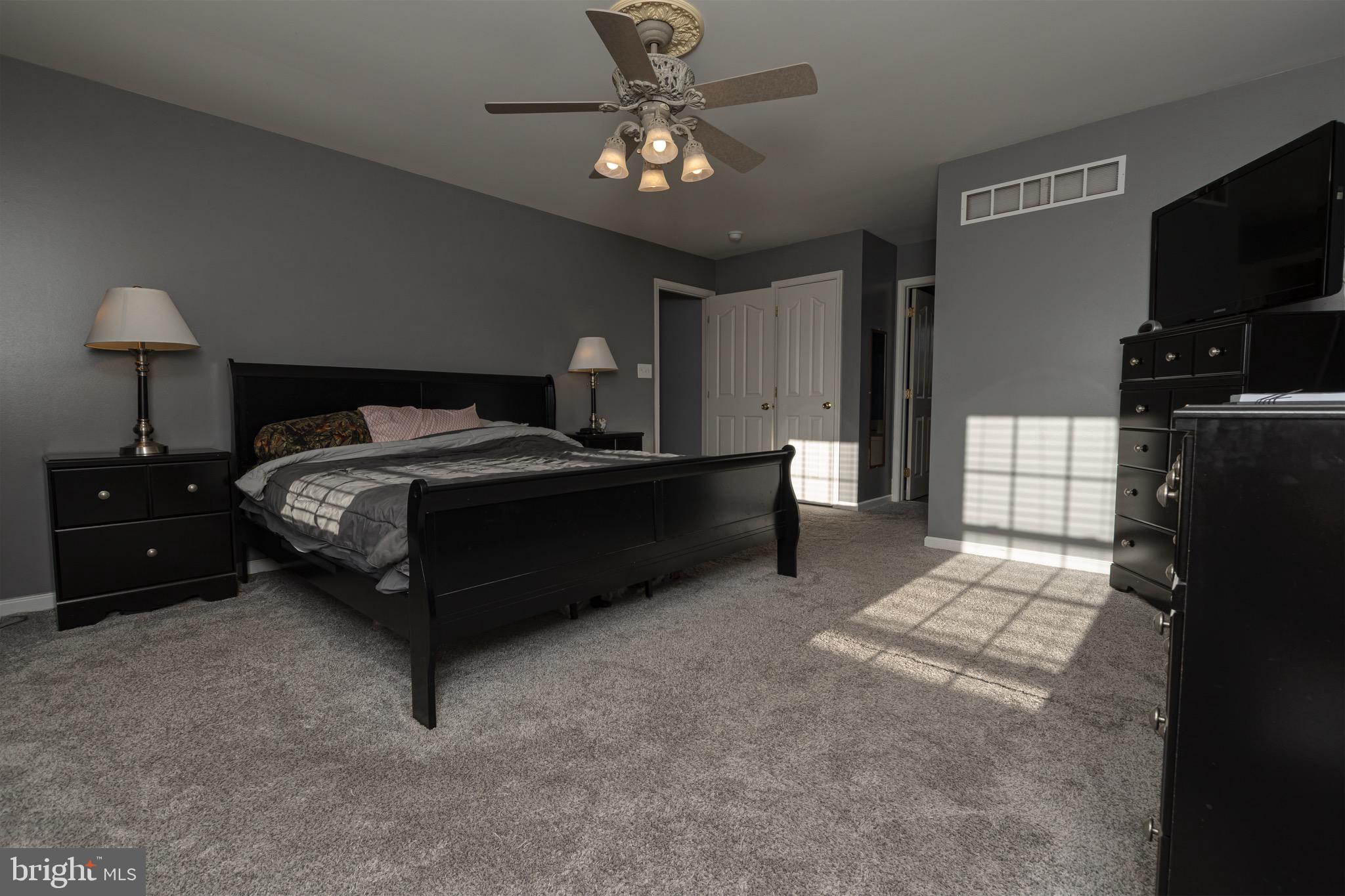27 Basalt Street Townsend, DE 19734 - Photo 25 of 46 a bedroom with a bed and a chandelier