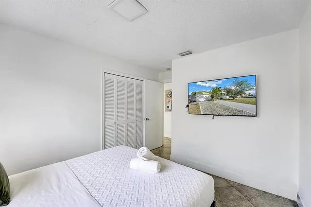 a bedroom with a bed and a painting on the wall