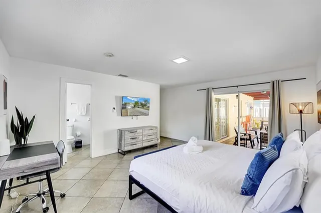 a bed room with a bed and a chair