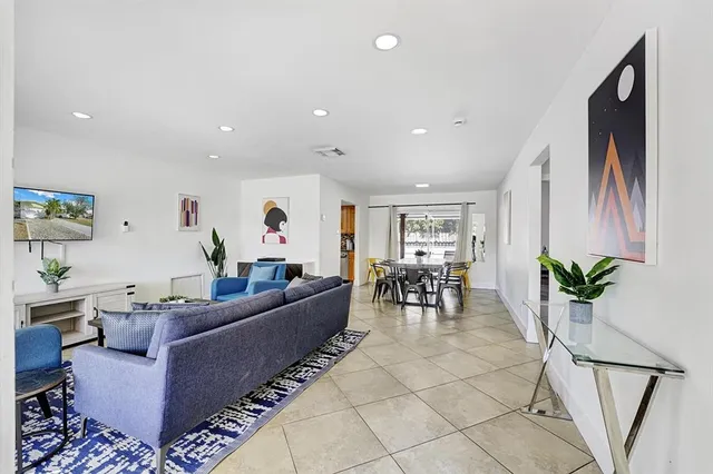 a living room with furniture and a potted plant