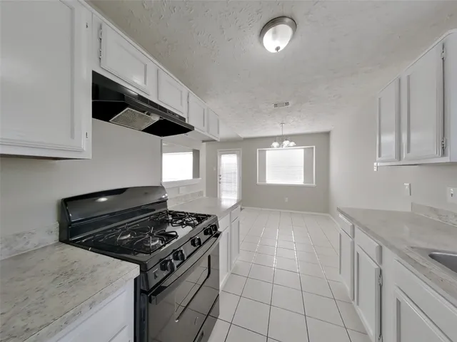 a kitchen with a stove and a sink