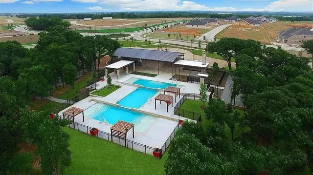 a view of a swimming pool with lounge chairs
