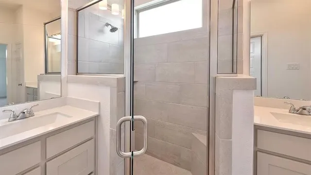 a bathroom with a sink shower and a mirror