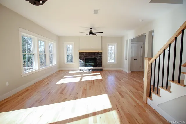 a view of a livingroom with wooden floor and fireplace