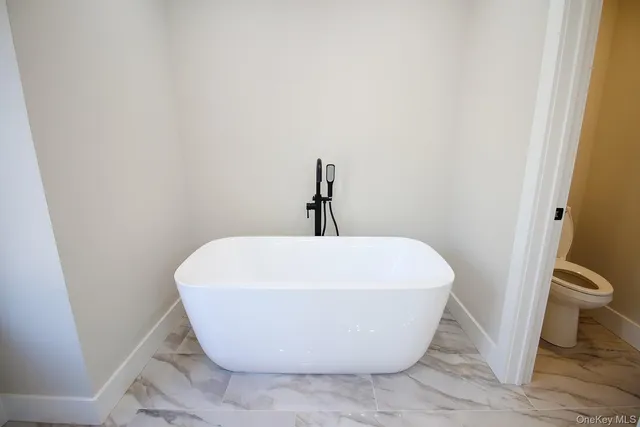 a view of an empty room and wooden floor