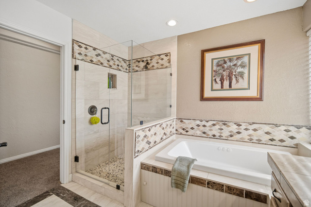 1985 West Rivers Edge Lane St. George, UT 84770 - Photo 26 of 42 Bathroom featuring a shower stall, a bath, vanity, a textured wall, and recessed lighting