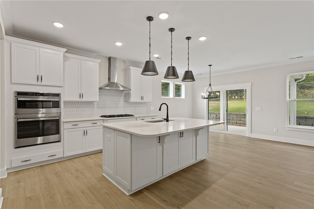 313 Old Shirley Road Central, SC 29630 - Photo 4 of 30 This bright, open kitchen features a large island and ample natural light, perfect for culinary endeavors.