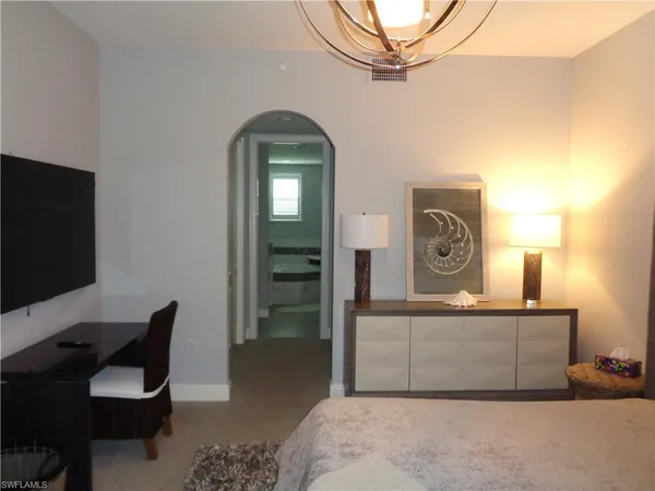 a bedroom with a bed and a television
