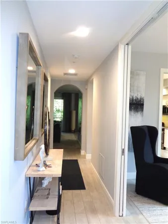 a view of a hallway with furniture and window