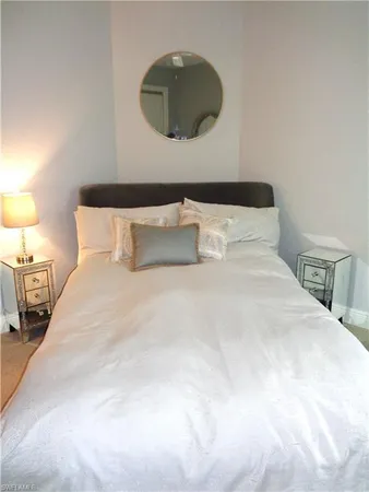 a bedroom with a bed and a lamp