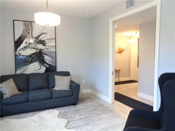 a view of a bedroom with furniture and wooden floor