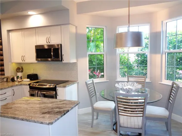 a kitchen with a wooden table and chairs