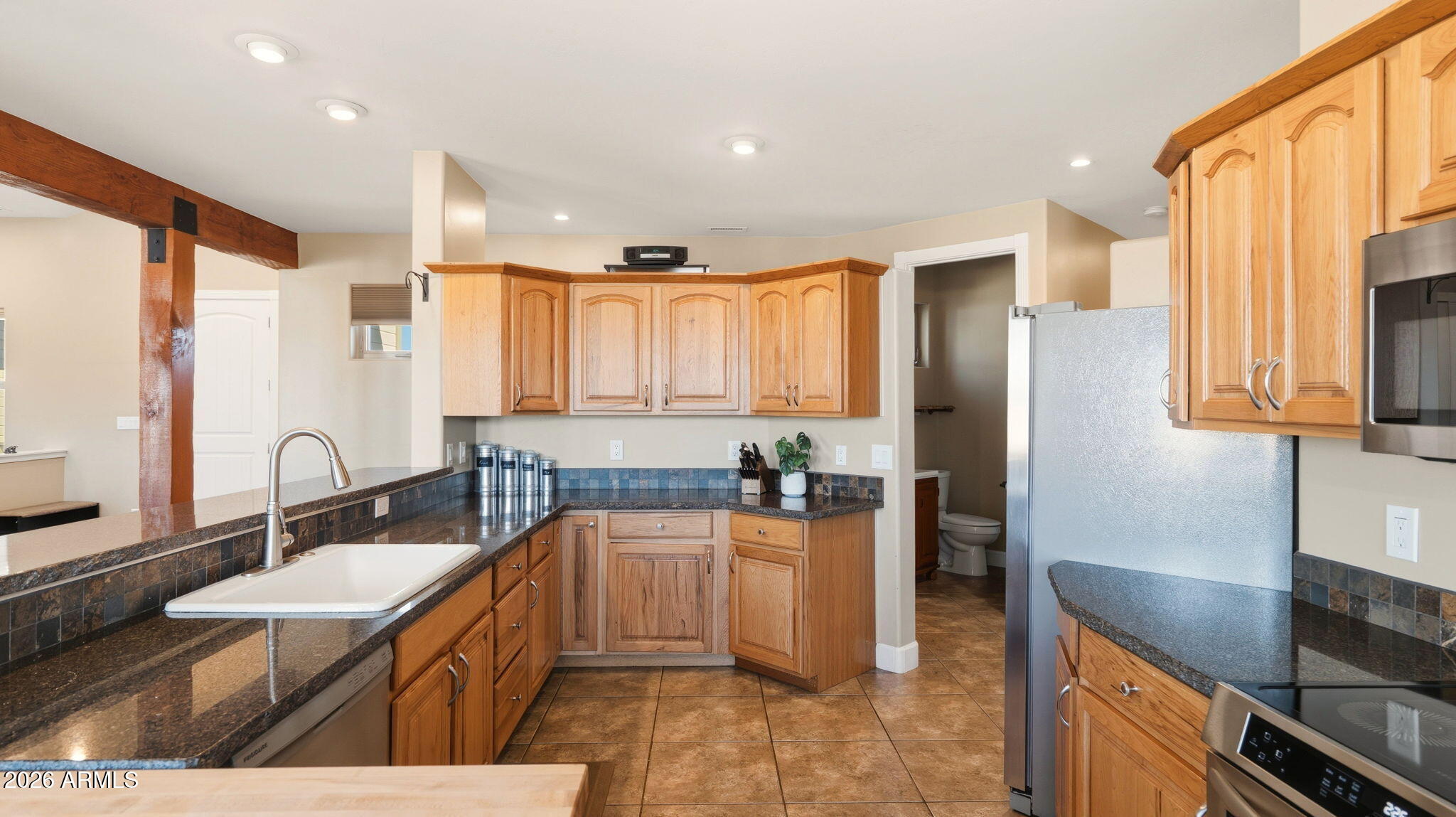 9630 North Aldrich Road Flagstaff, AZ 86004 - Photo 14 of 47 a large kitchen with kitchen island a sink stainless steel appliances and cabinets