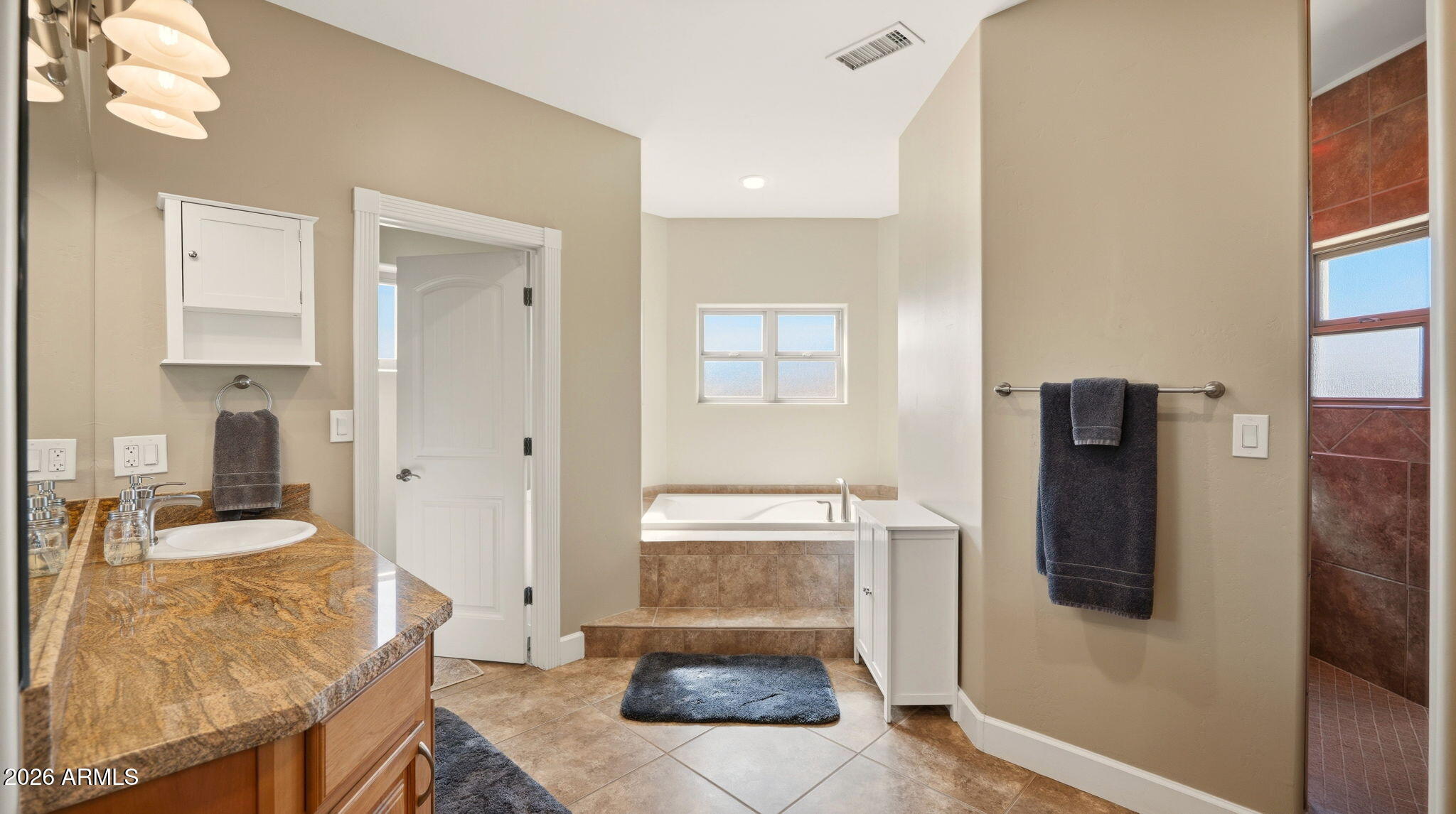9630 North Aldrich Road Flagstaff, AZ 86004 - Photo 21 of 47 a bathroom with a granite countertop sink and a mirror