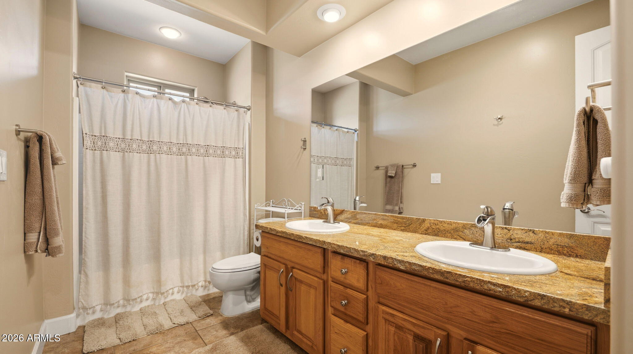 9630 North Aldrich Road Flagstaff, AZ 86004 - Photo 24 of 47 a bathroom with double vanity sinks a toilet a mirror and shower