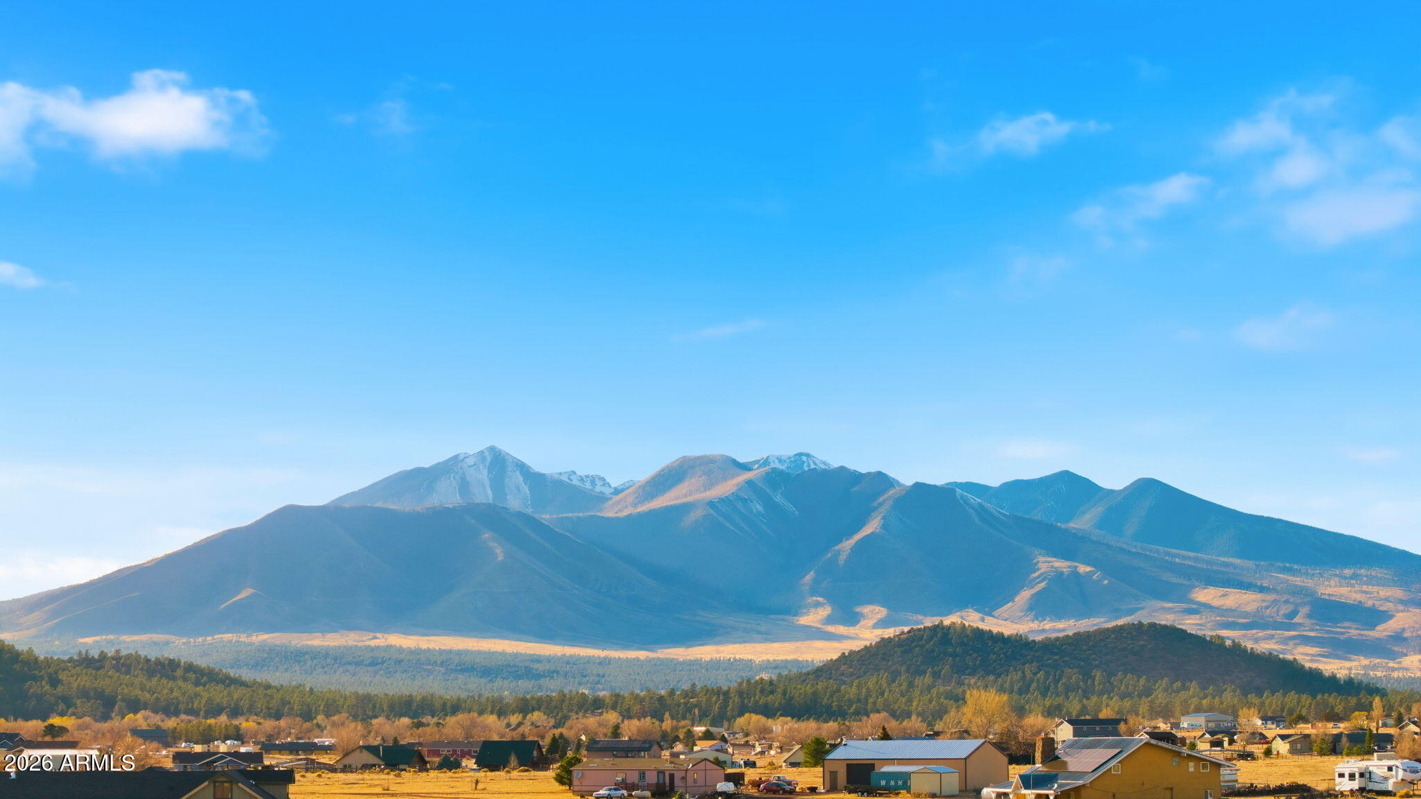 9630 North Aldrich Road Flagstaff, AZ 86004 - Photo 2 of 47 a view of a large building with a mountain in the background