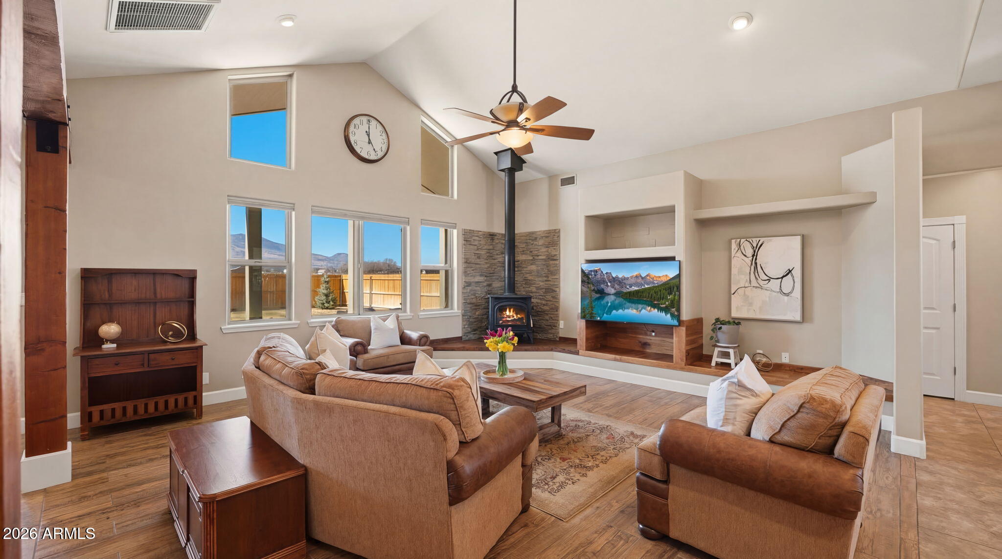 9630 North Aldrich Road Flagstaff, AZ 86004 - Photo 9 of 47 a living room with furniture a clock and a ceiling fan