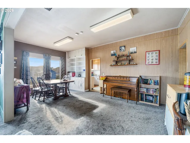 a living room with furniture a dining table and a fireplace