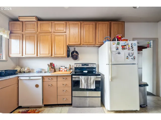 a white refrigerator freezer sitting inside of a kitchen
