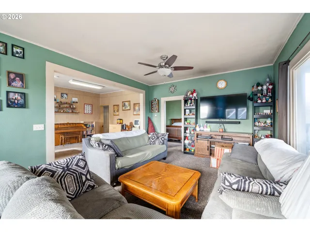 a living room with furniture a rug and a flat screen tv