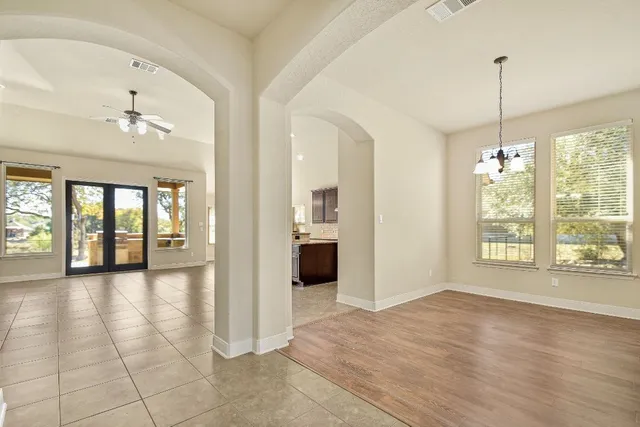 a view of an empty room with window and cabinet